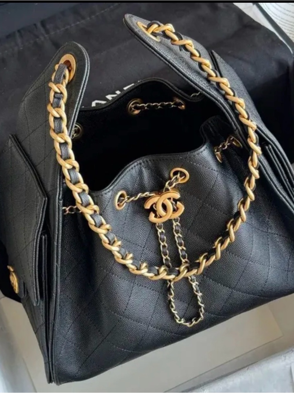 Black Quilted Drawstring Shoulder Bag with Gold-Tone Chain and CC Charm